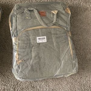 Diaper bag that folds out to a play pen or a changing table